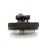 Self-cleaning slicker brush head with metal pins under a black housing