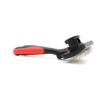 Self-cleaning slicker grooming brush with hinged pin head and red-and-black handle