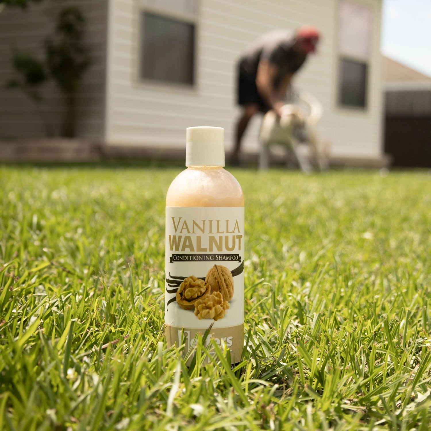 Vanilla walnut conditioning shampoo bottle on grass, front label visible