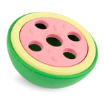 Watermelon-shaped rubber chew toy with pink top and six circular treat holes