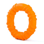 Orange wavy ring natural rubber dog chew toy, angled view