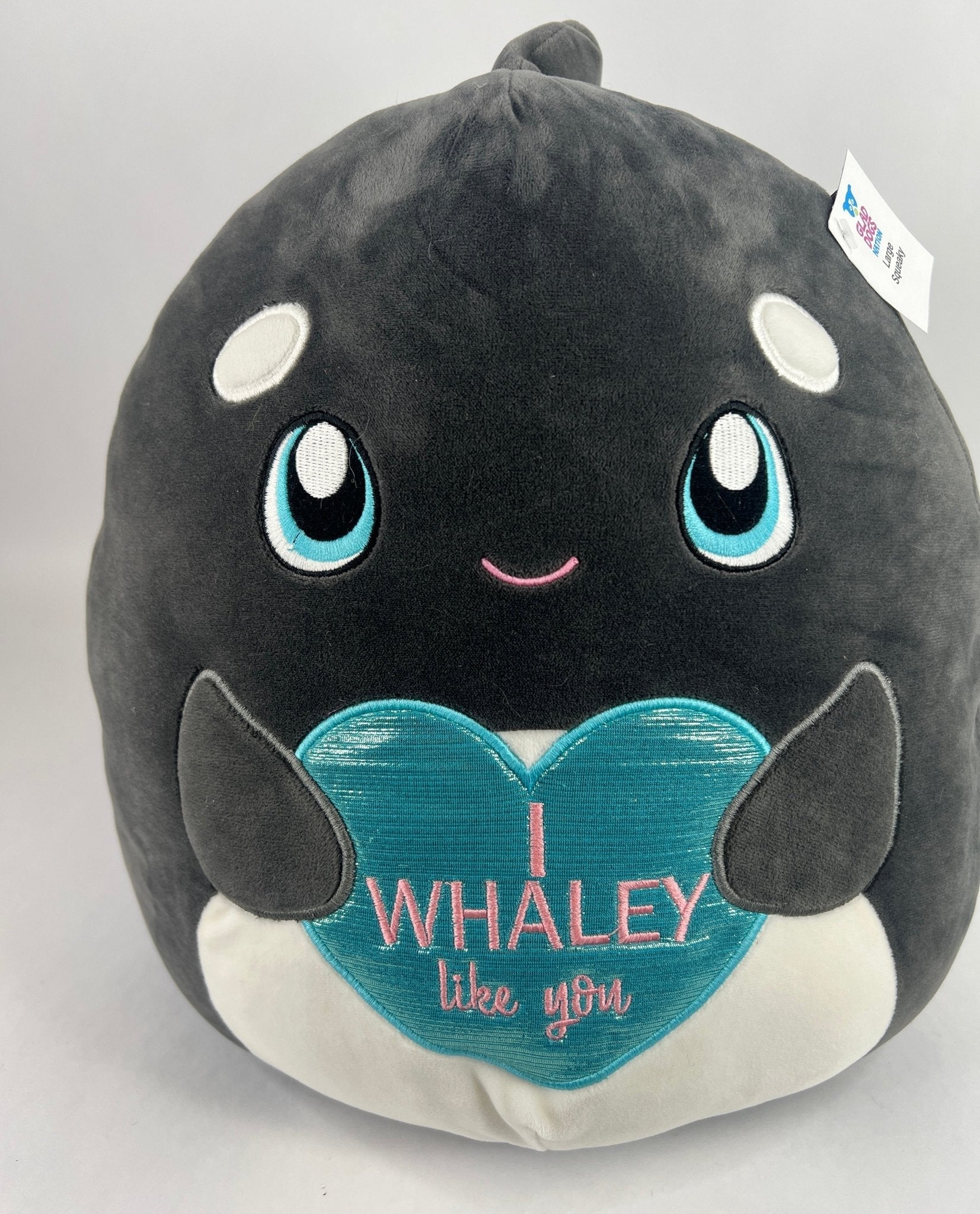 Large squishy whale plush pet toy, dark gray with blue eyes and "WHALEY" text