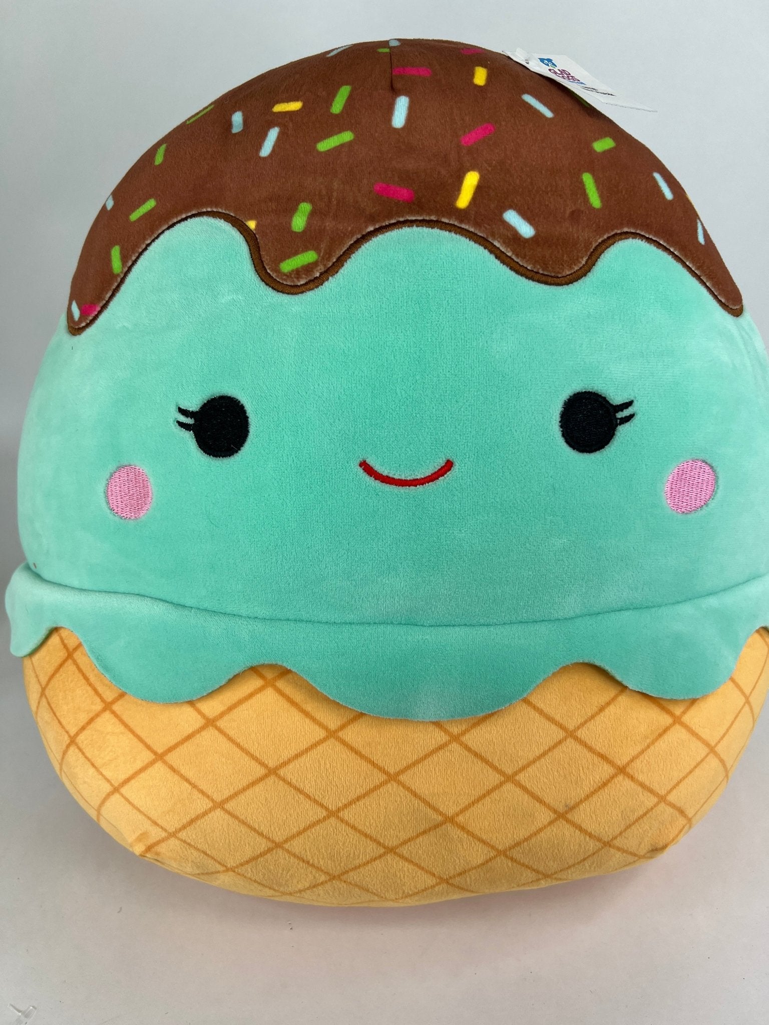 Large squishy ice cream plush, teal scoop with sprinkles and tan waffle cone base