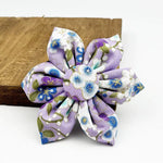 Lilac floral bow accessory with blue flower pattern and fabric petals