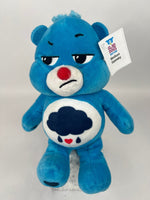 Blue plush dog toy bear with cloud belly patch and red nose, sleepy smile.