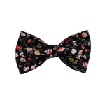 Floral pet bowtie accessory with black base and gold knot center