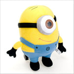 Yellow minion plush with blue overalls, big goggles, smiling face, black hands and feet