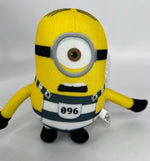 Yellow Minion plush with round gray goggles and black belt badge marked 096