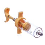 Tan nylon syringe with clear barrel and printed measurement scale, metal tip