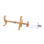 Tan nylon syringe with clear barrel and measurement marks, thumb handles