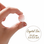Rose quartz tumbled stone held between fingers; size 15–20 mm shown