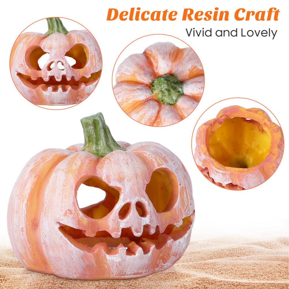 Pumpkin resin fish shelter with carved face, green stem, hollow cavity showing yellow inside
