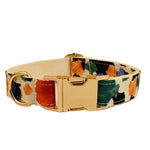 Floral pet collar with buckle and gold hardware, beige base with orange, green, and blue prints