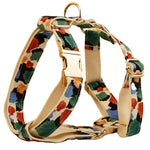 Floral pet harness with gold rings and straps, beige base with orange and green leaf pattern
