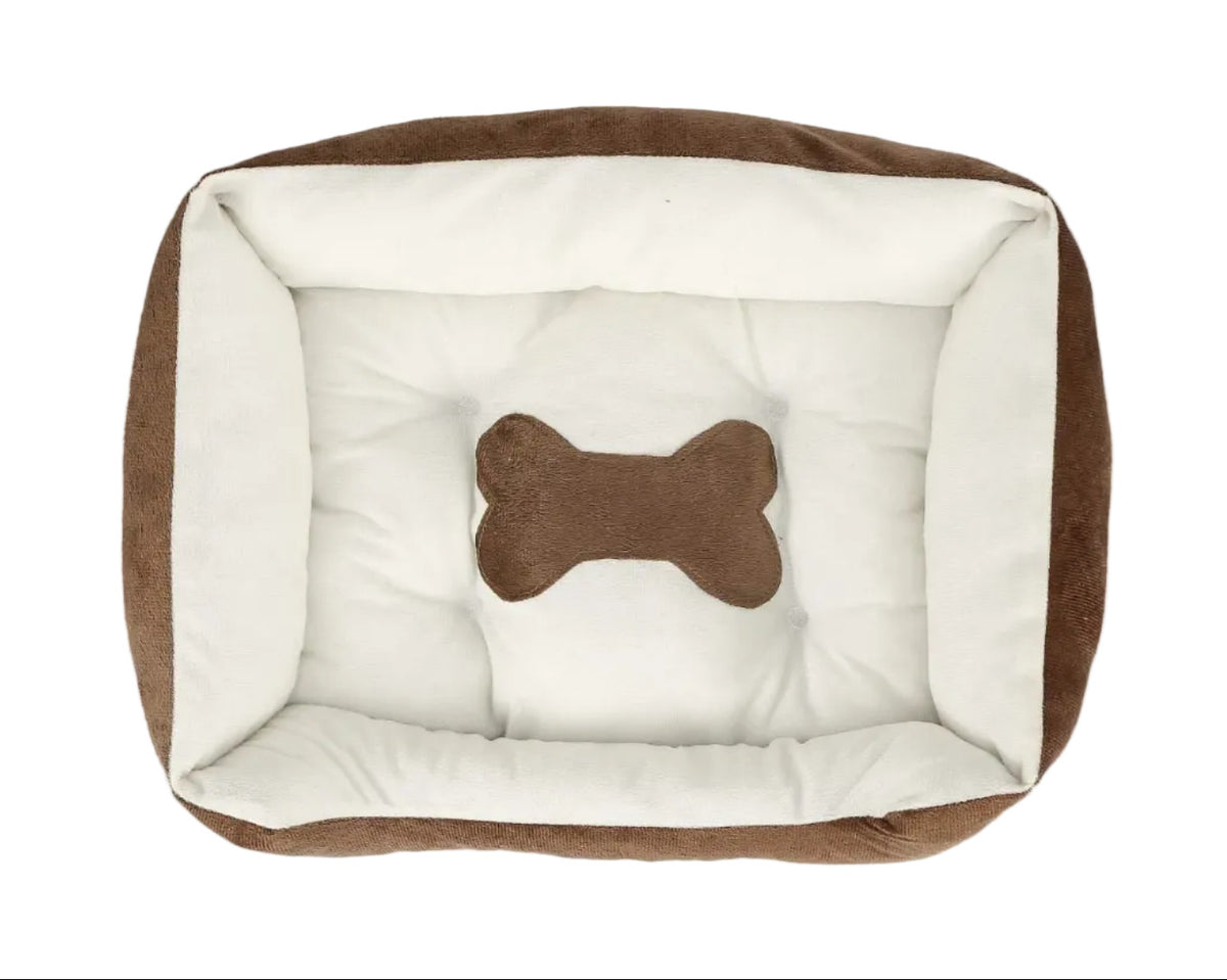 Brown and white plush dog bed with padded white floor and brown bone cushion.
