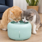 Mint-green dog and cat water fountain with two cats drinking from the basin