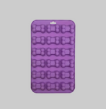 Purple silicone pet treat mold with bone-shaped cavities in a square tray.