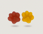 Red and yellow silicone pet treats in paw shapes