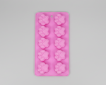 Pink silicone pet treat mold with paw print cavity shapes