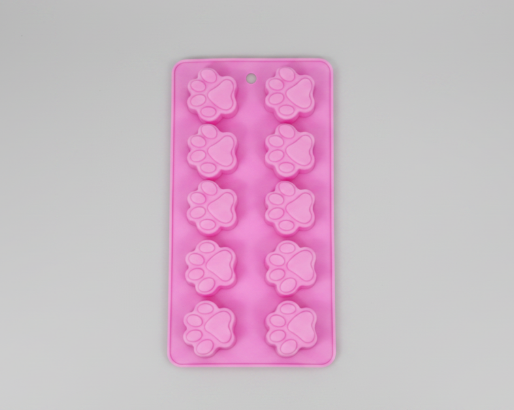Pink silicone pet treat mold with paw print cavity shapes