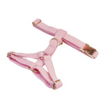 Pink corduroy dog harness and matching leash straps with gold buckles