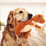 Orange animal-shaped rubber molar chew toy figure with textured body, held by a dog
