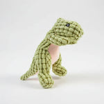 Green animal-shaped rubber molar chew toy with textured scales and black button eyes