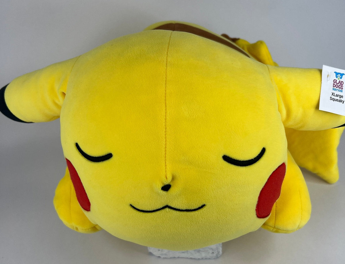 Stuffed plush dog toy, sleepy yellow Pikachu-style plush with eyes closed and squeaker tag