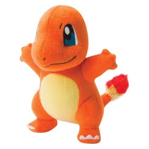 Stuffed plush dog toy, orange lizard-like character with blue eye, cream belly, and red paw details