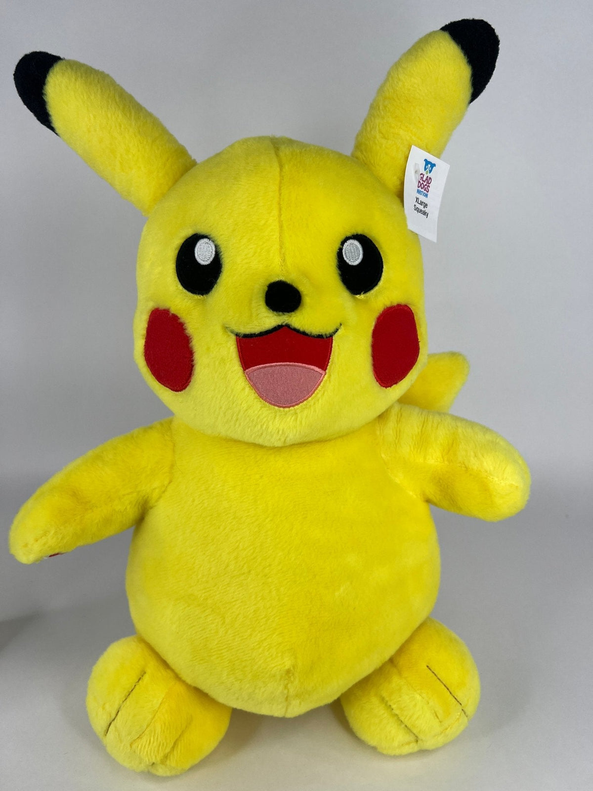 Stuffed plush dog toy, bright yellow mouse-like character with smiling face and long ears