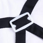 Close-up of black overalls strap and white button detail on pet suit