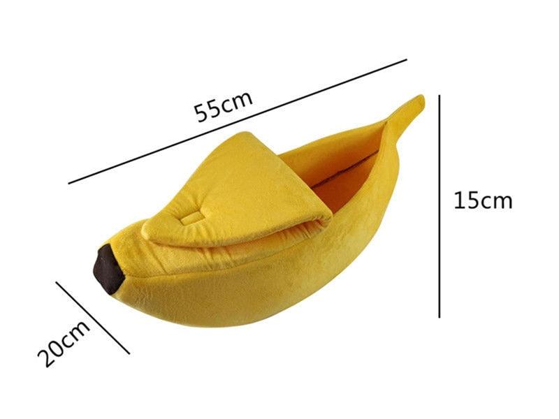 Banana-shaped pet bed in yellow fabric with darker end tip and raised cushioned rim