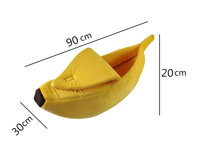 Banana-shaped pet bed in yellow plush with folded headrest and darker end tip