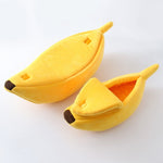 Yellow banana-shaped pet bed with plush interior lining and rounded opening