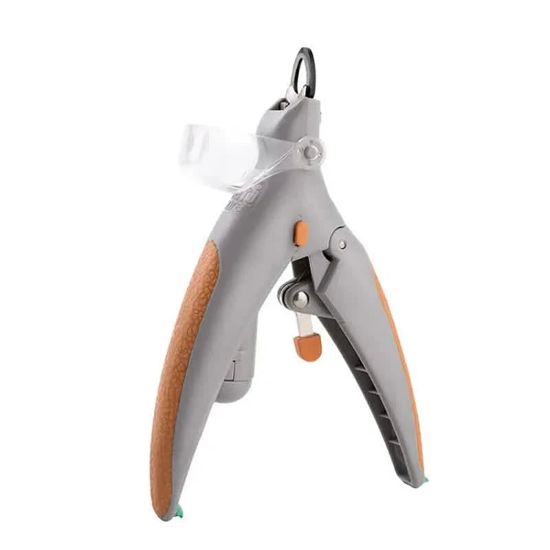 Pet nail clipper scissors with gray arms and orange grip, standing view