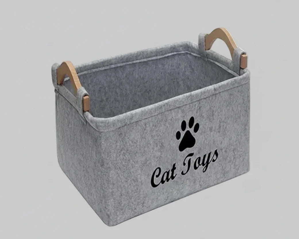 Light grey felt storage basket with cat paw emblem and wooden handle straps