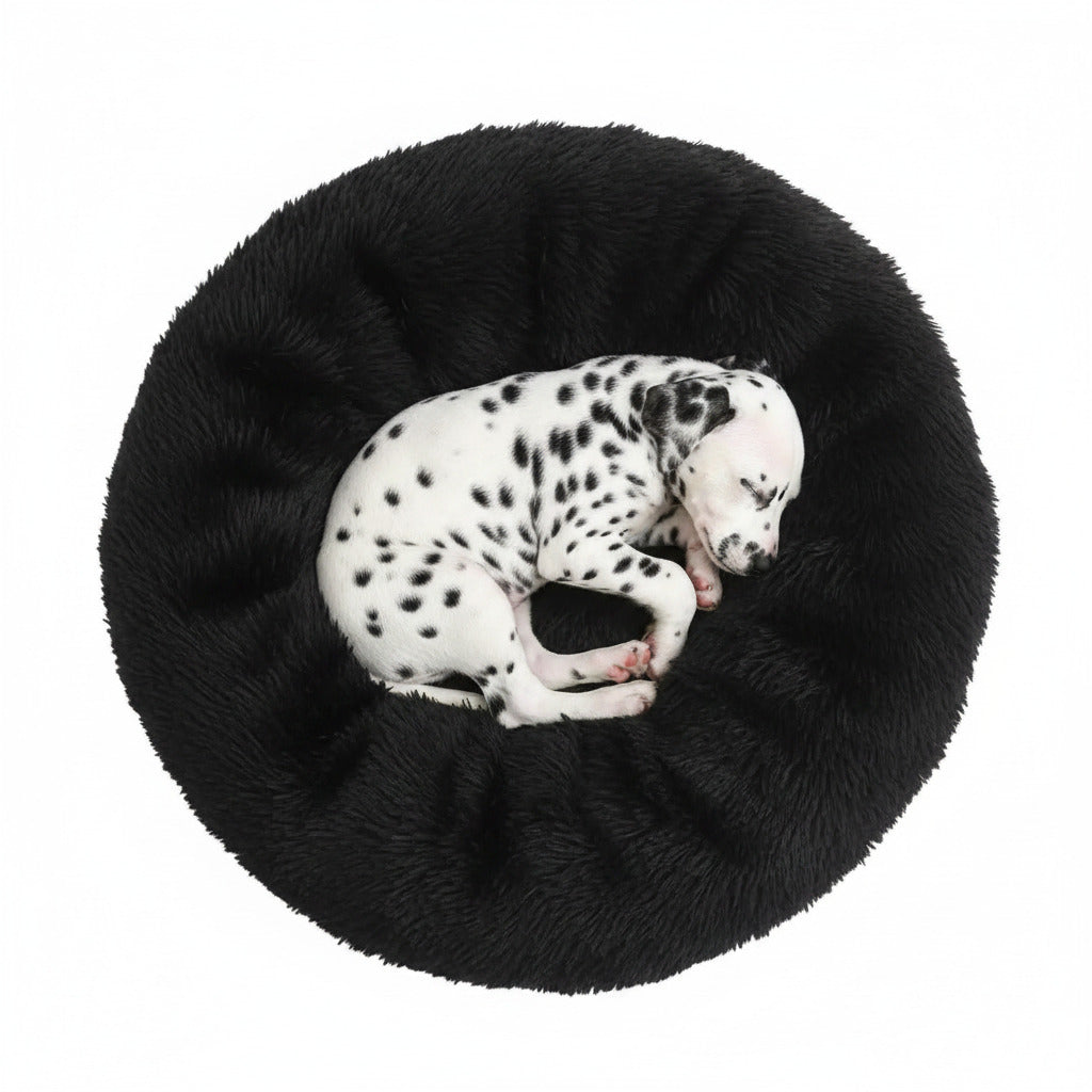 Plush donut pet bed in black, with Dalmatian puppy curled inside