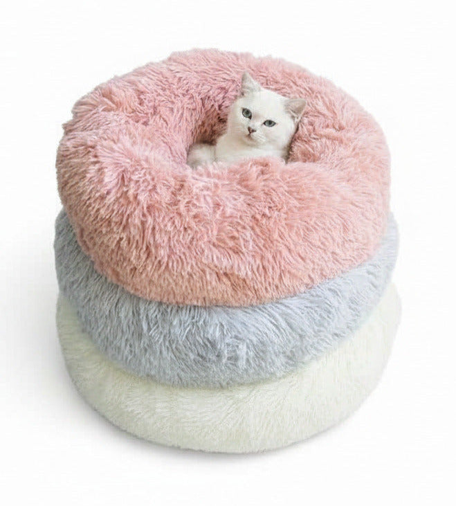 Plush pet bed with donut shape, blush pink top and light gray bottom