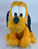 Yellow plush dog toy with black ears and muzzle, embroidered eyes, tag