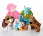 Assorted plush animal dog toys in pink, green, blue, and brown