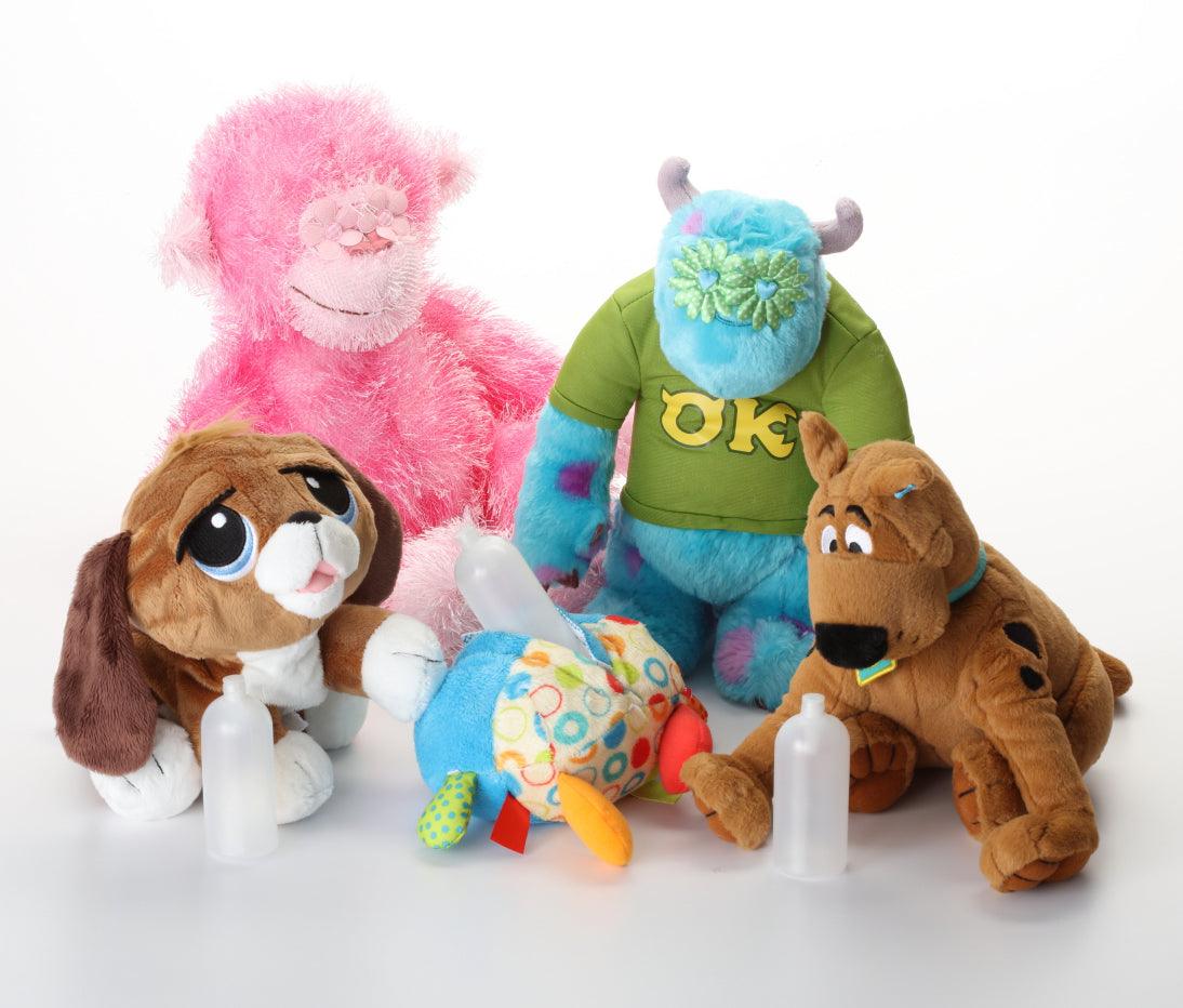 Assorted plush animal dog toys in pink, green, blue, and brown