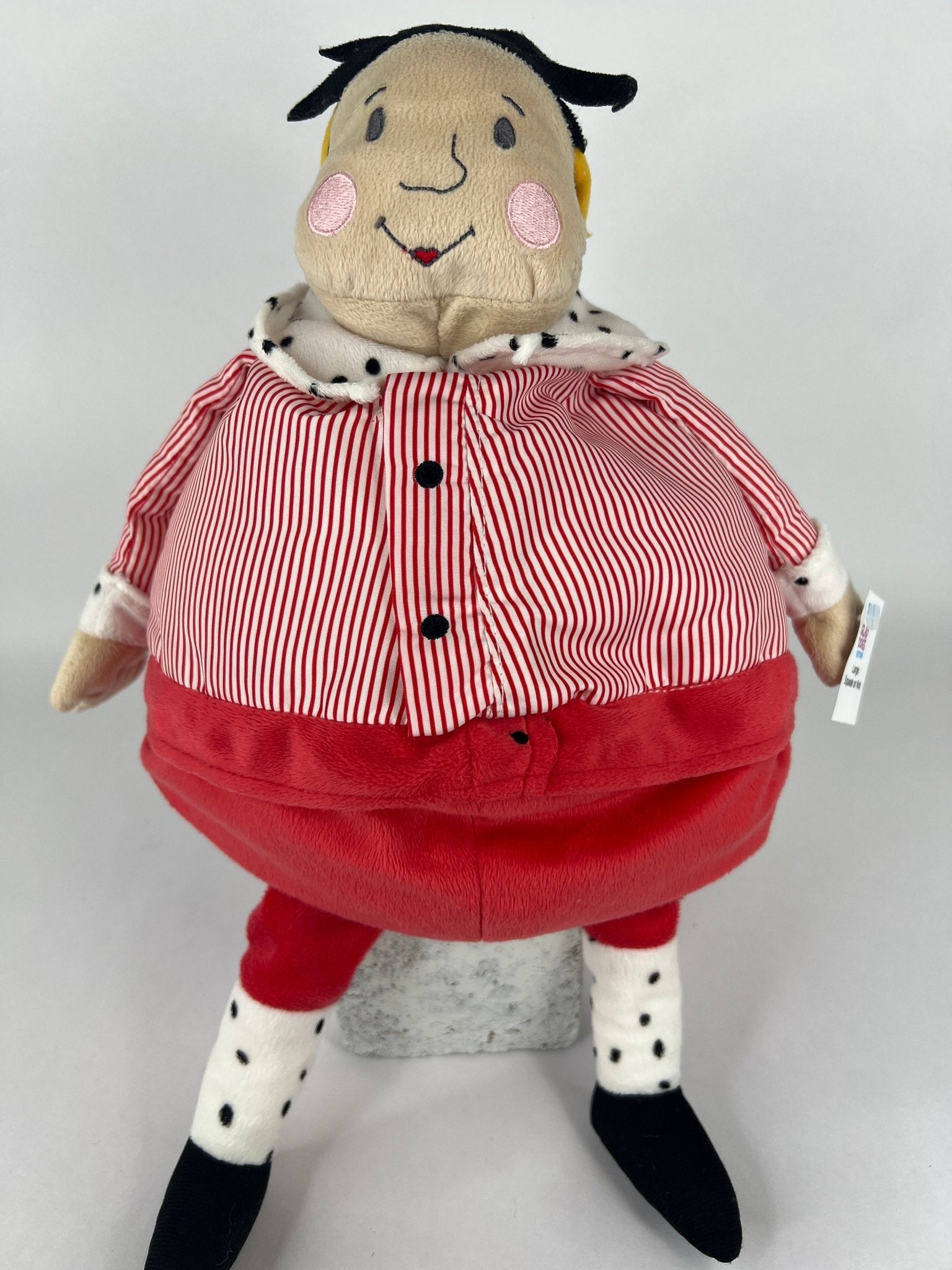 Beige plush character dog toy with red striped shirt and button front