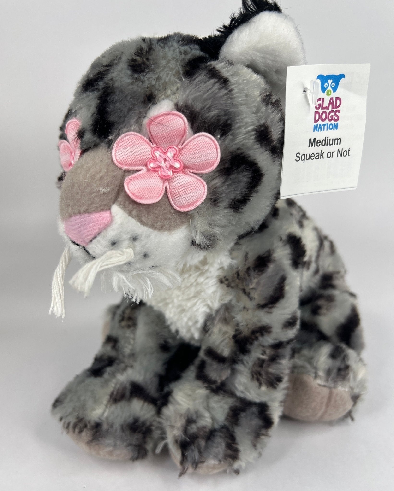 Gray and black spotted plush dog toy with pink bow nose, squeaker tag