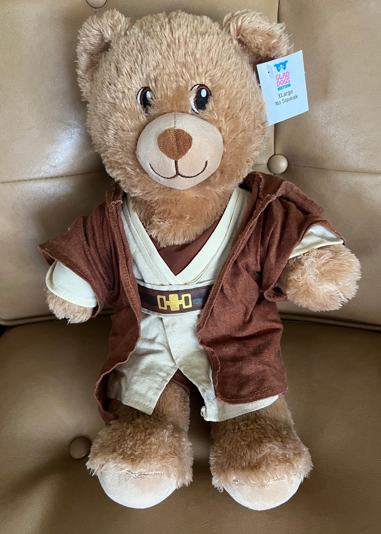 Brown teddy dog toy with Star Wars-style vest and hoodie, plush face and tag