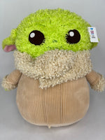 Green-and-cream plush dog toy with large black eyes and fuzzy rounded body