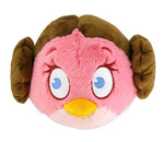 Pink and brown plush dog toy face with blue eyes and yellow beak, rounded shape