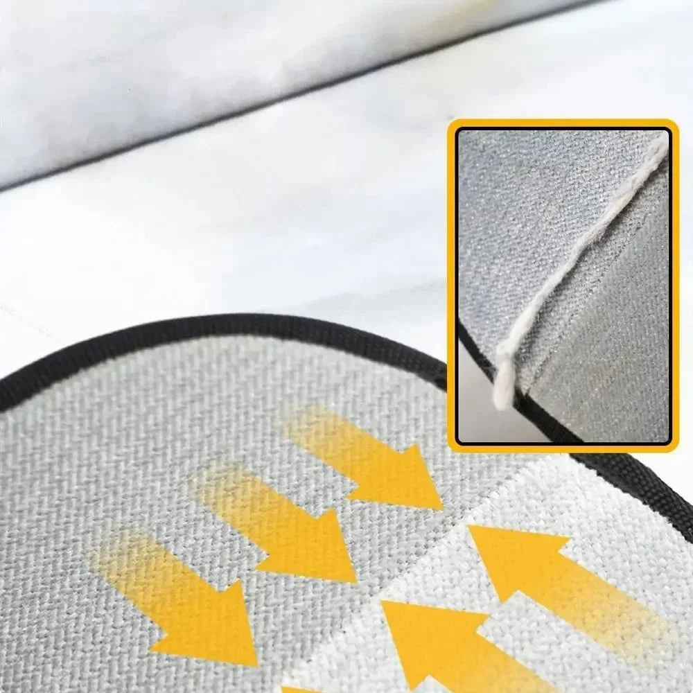 Close-up of gray inner pad on black pet grooming mitt with yellow arrows