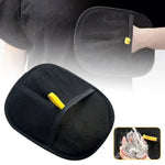 Black pet grooming hair-removal mitt with yellow tab, close-up of textured pad