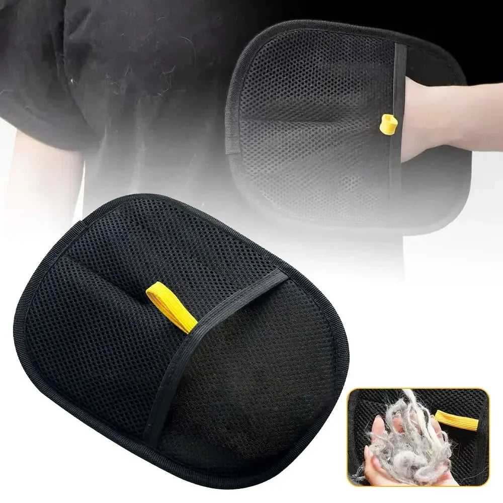 Black pet grooming hair-removal mitt with yellow tab, close-up of textured pad