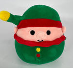Green holiday elf plush with red hat band, cute face, and small button details